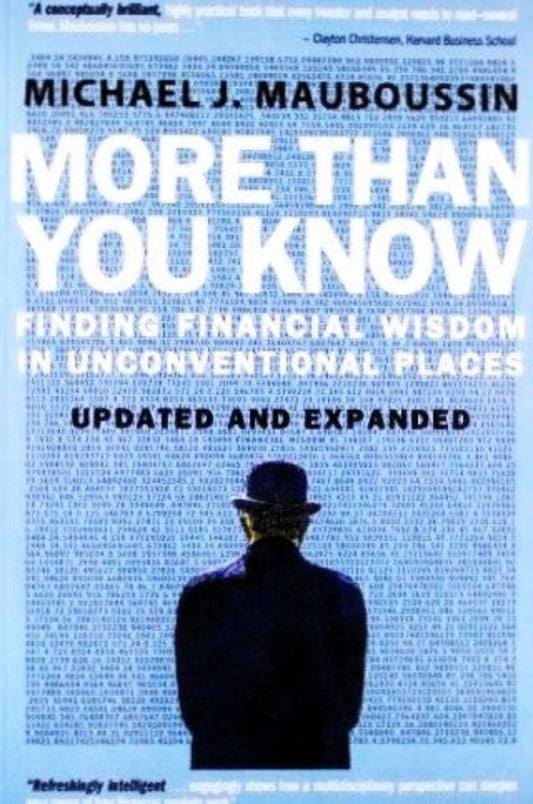 Book cover of 'More Than You Know: Finding Financial Wisdom in Unconventional Places' by Michael J. Mauboussin with a silhouette of a person wearing a hat against a blue background and looking at a newspaper wall, wearing a suit and dob hat.