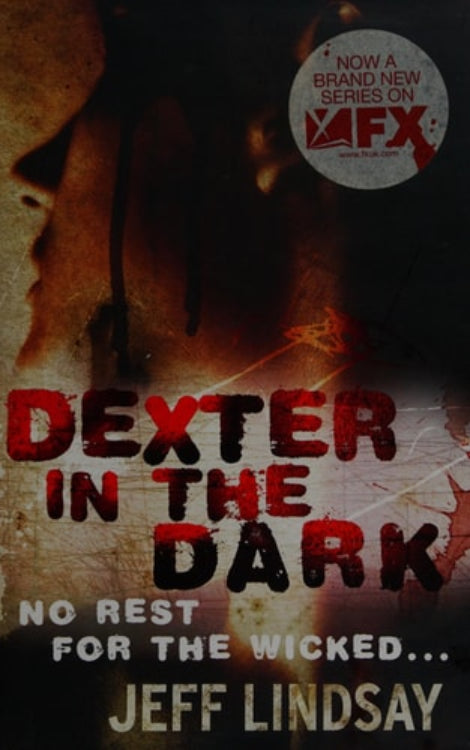 Book cover for 'Dexter in the Dark' featuring a man's face with a dark, blurred background.