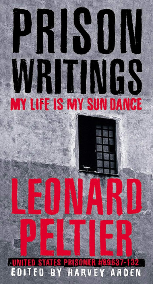 Book cover of 'Prison Writings: My Life Is My Sun Dance' by Leonard Peltier, edited by Harvey Arden. The cover features a dark, grainy photo of a person behind bars with a red and black text overlay.