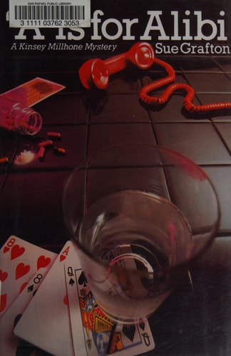 Book cover of 'A is for Alibi' by Sue Grafton featuring a glass, playing cards, and a red phone on a table.