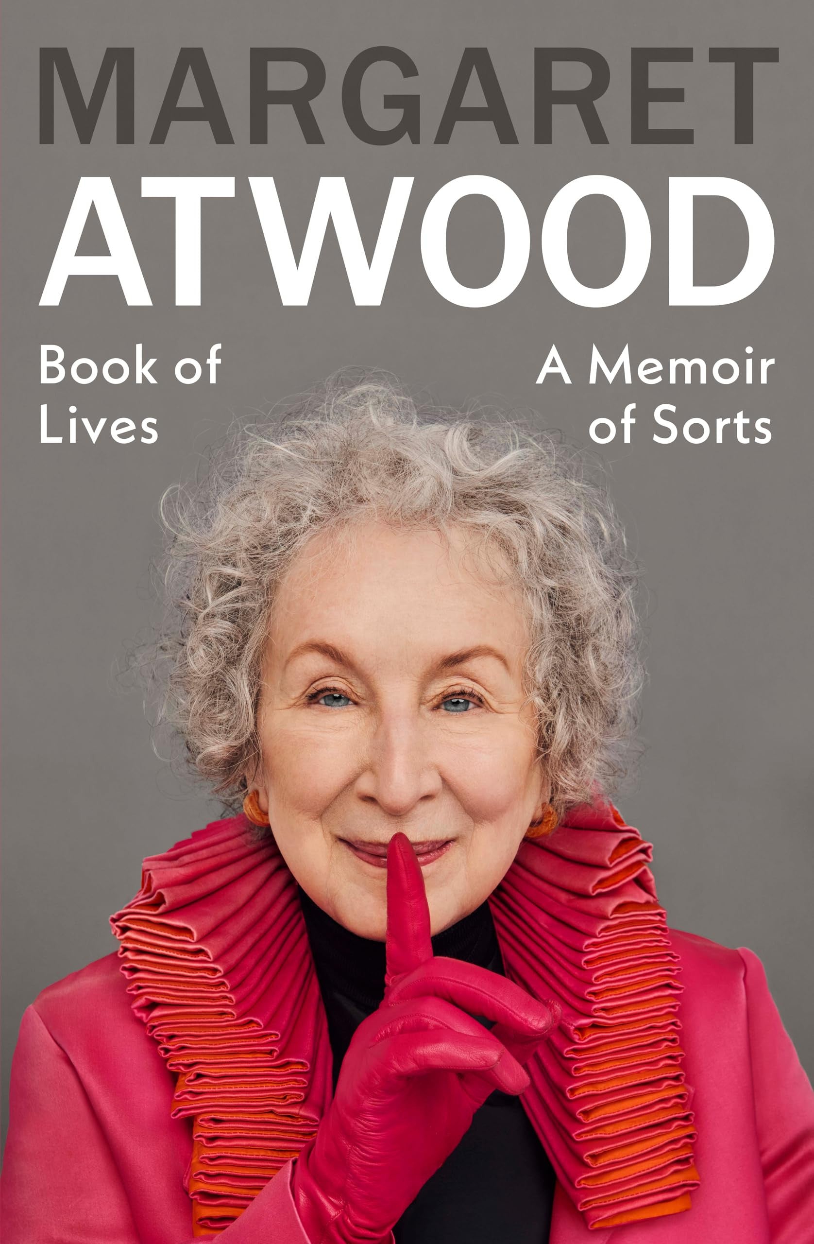 Book cover featuring Margaret Atwood with a red scarf and pink gloves, with text about 'Book of Lives' and 'A Memoir of Sorts' by Margaret Atwood.
