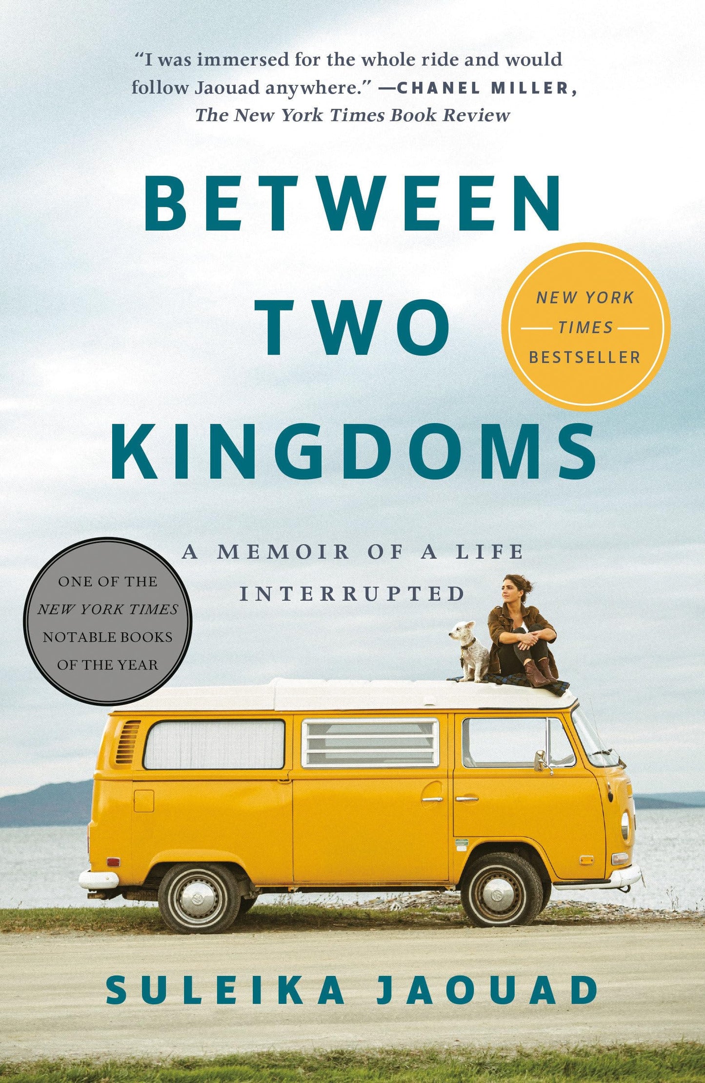 Book cover for 'Between Two Kingdoms' by Suleika Jaquod, featuring a yellow vintage VW bus on a beach with a woman riding a dog, set against a light blue sky and ocean background.