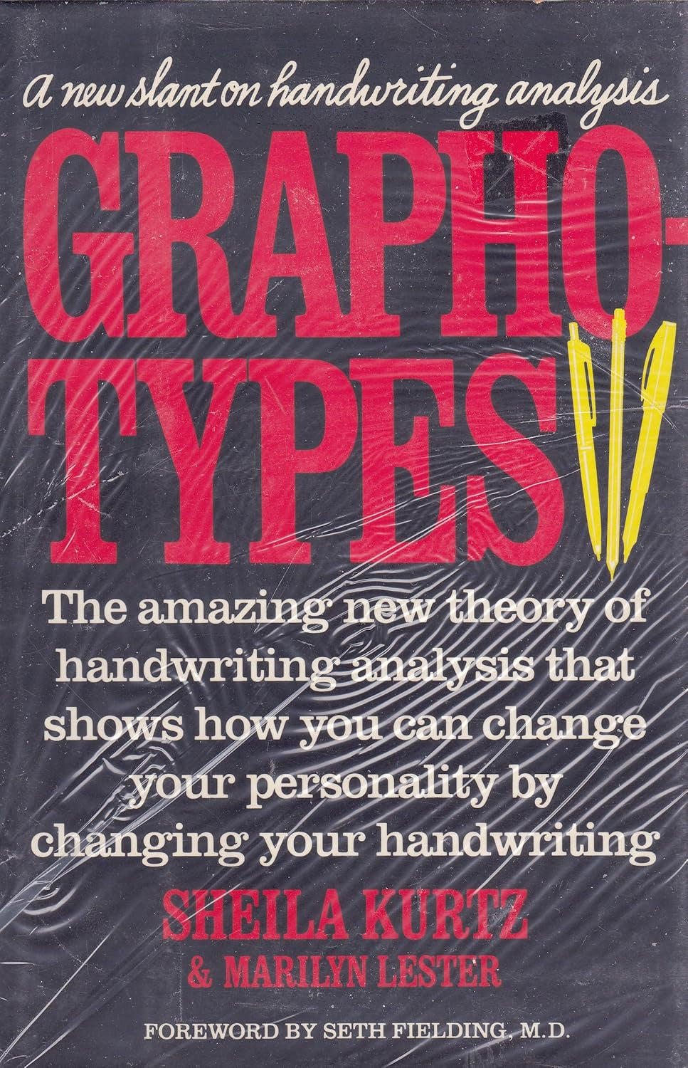 The cover of the book 'Graphotypes' by Sheila Kurtz & Marilyn Lester features a black background with red and yellow text, detailing the new slant on handwriting analysis and the amazing new theory of handwriting that can change your personality.