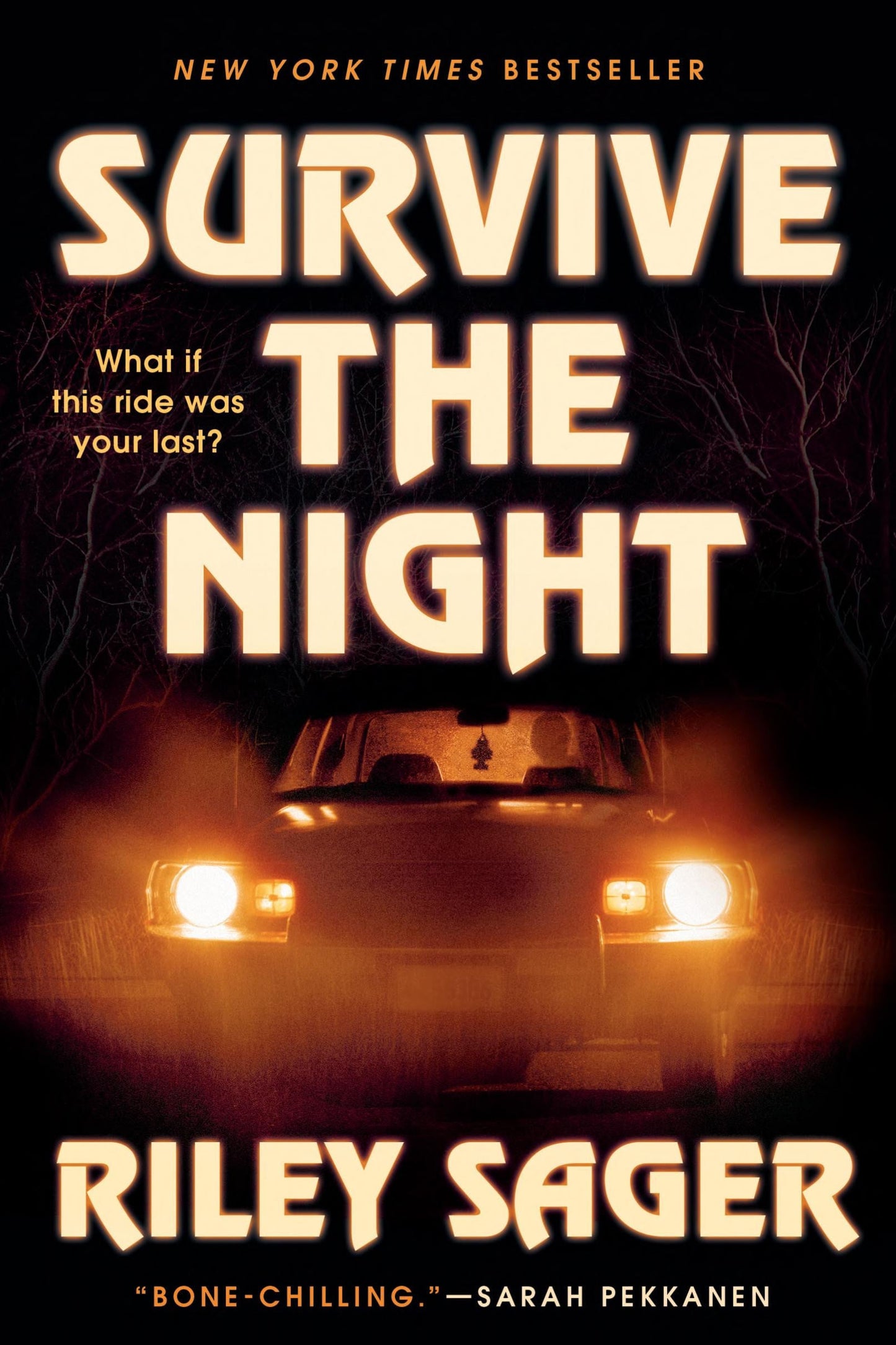 Book cover for 'Survive the Night' by Riley Sager, featuring large glowing cream title text over a dark night scene with bare trees and the headlights of a car.