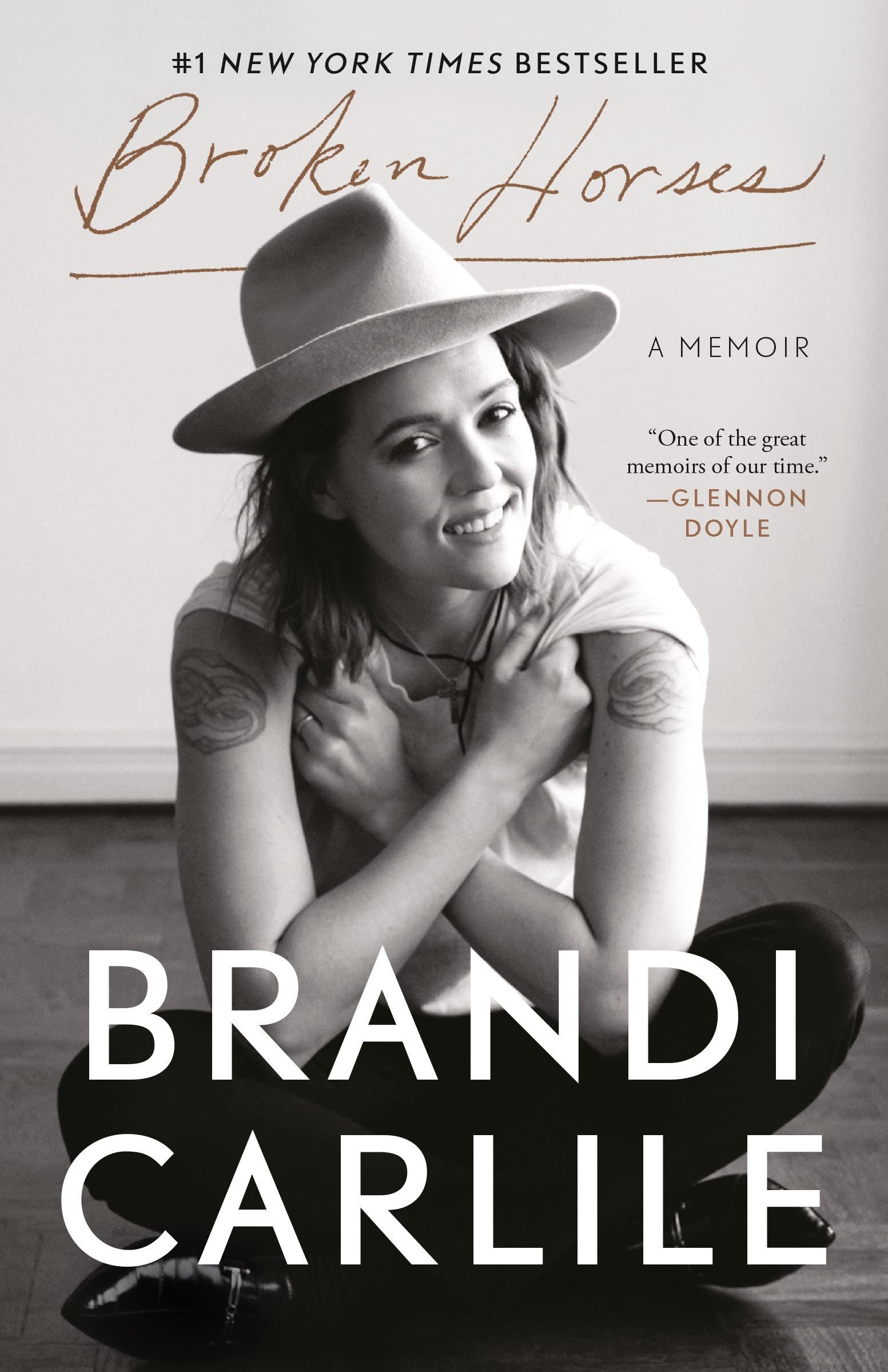 Book cover of 'Broken Horses' by Brandi Carlile featuring a woman in a hat.