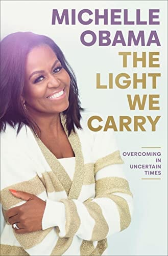 Book cover of 'The Light We Carry: Overcoming in Uncertain Times' by Michelle Obama, featuring a photograph of the author, former First Lady Michelle Obama smiling.
