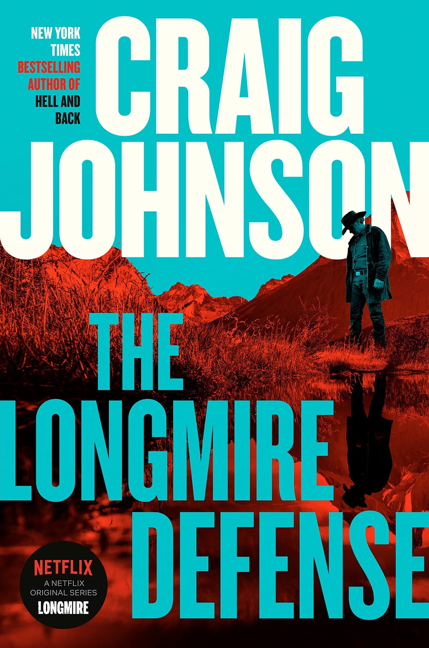 Book cover of 'The Longmire Defense' by Craig Johnson with a cowboy standing in water and mountains in the background.