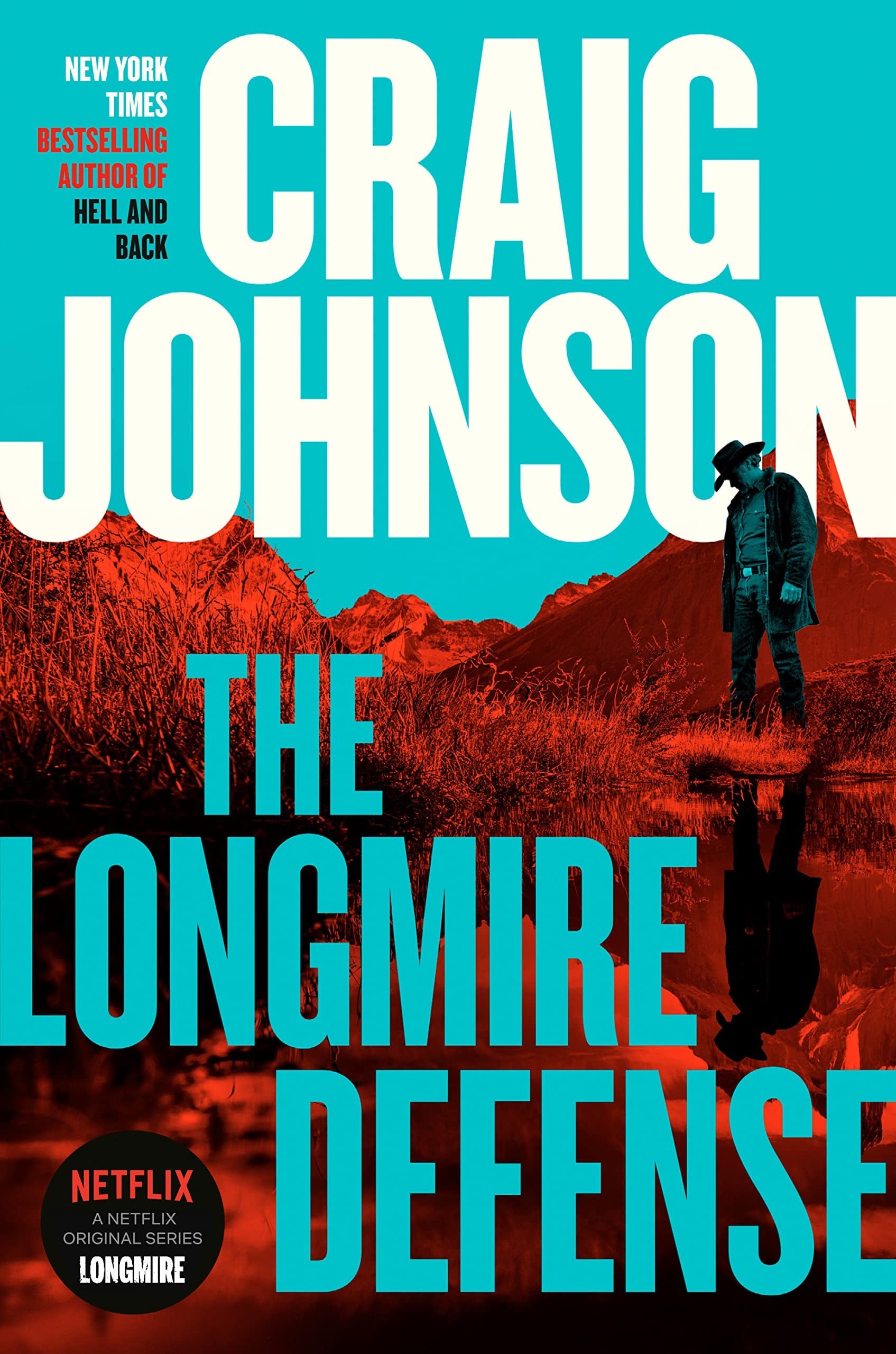 Book cover of 'The Longmire Defense' by Craig Johnson with a cowboy standing in water and mountains in the background.