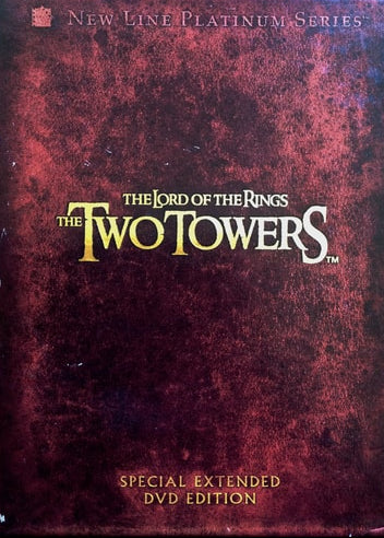 DVD cover of 'The Two Towers' from 'The Lord of the Rings' with a maroon background and gold text.