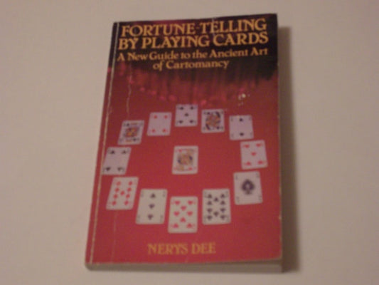 Book titled 'Fortune-Telling by Playing Cards' by Nerys Dee on a beige background