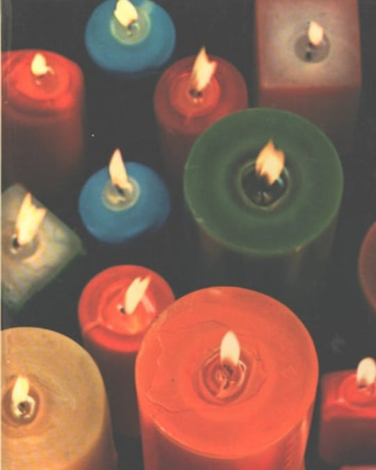 Book front cover of 'The Family Creative Workshop [Volume 3]: Boxes to Card Tricks' featuring collection of colorful candles with a bright flame, arranged closely together.