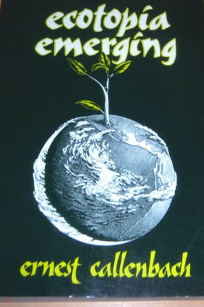 Book titled 'ecotopia emerging' by Ernest Callenbach on a wooden surface