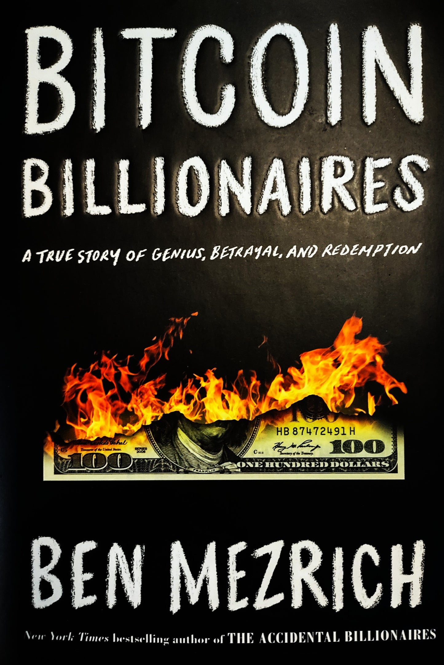 Book cover of 'Bitcoin Billionaires' by Ben Mezrich with a dollar bill on fire.