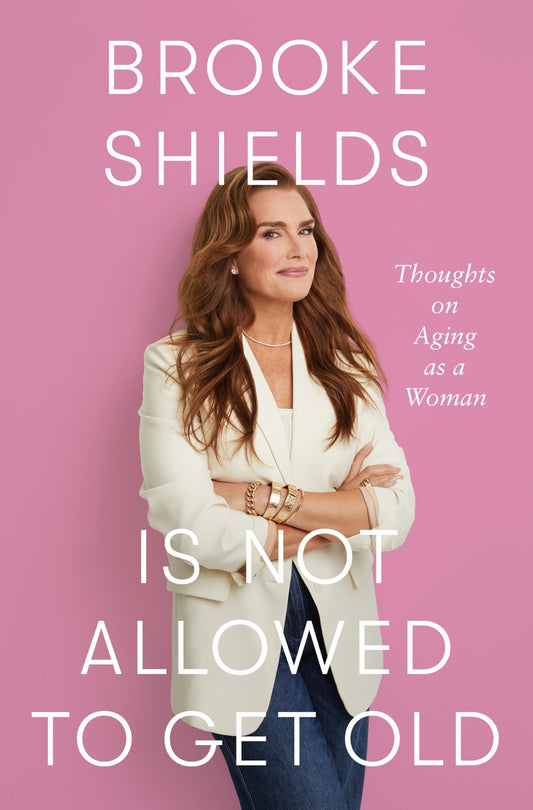Book front cover of 'Brooke Shields Is Not Allowed to Get Old: Thoughts on Aging as a Woman' by Brooke Shields, featuring the author wearing a blazer and posing over a pink background.