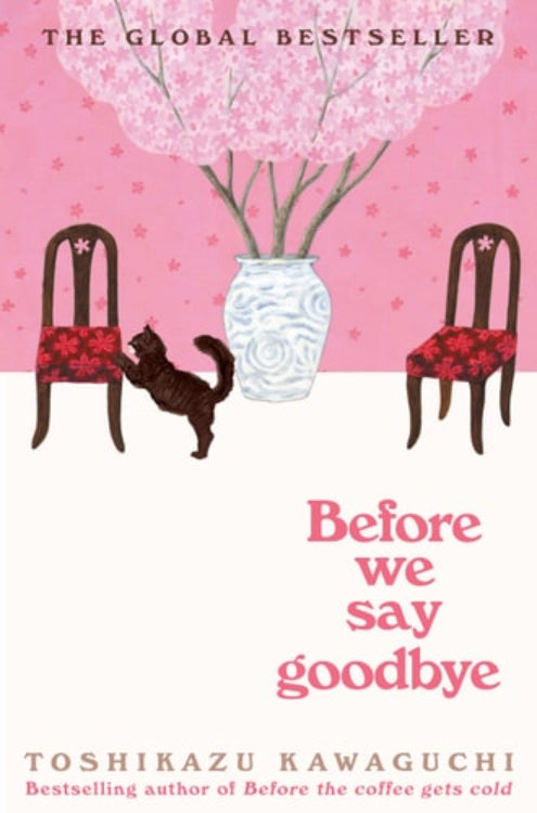 Book cover of 'Before We Say Goodbye' by Toshikazu Kawaguchi featuring two chairs and a table with a vase on it against a pink background.
