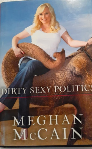 The cover of the book 'Dirty Sexy Politics' by Meghan McCain, featuring the author sitting on a camel.