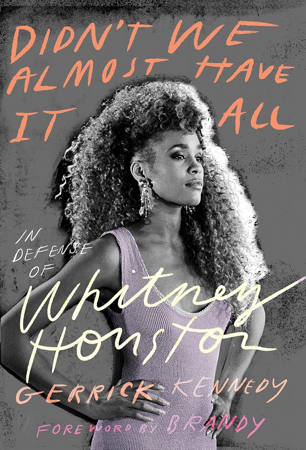 Book cover of 'Didn't We Almost Have It All: Defense of Whitney Houston' by Gerrick Kennedy, featuring an image of Whitney Houston with text in orange and white.