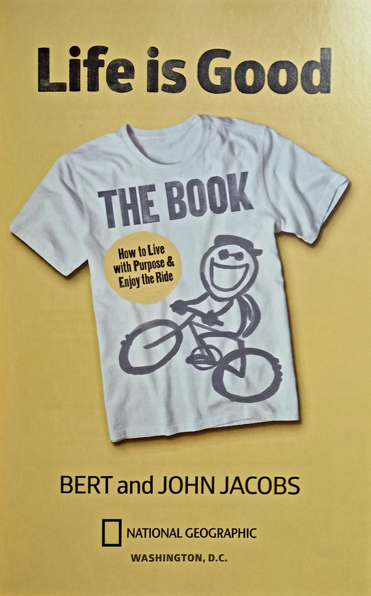 The cover of the book 'Life is Good: The Book' by Bert and John Jacobs, featuring a white t-shirt with the title and the brand's logo, against a yellow background.