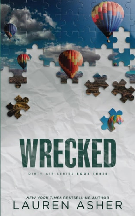 Book cover of 'Wrecked' by Lauren Asher featuring a puzzle motif with images of hot air balloons and puzzle pieces against a blue sky background.
