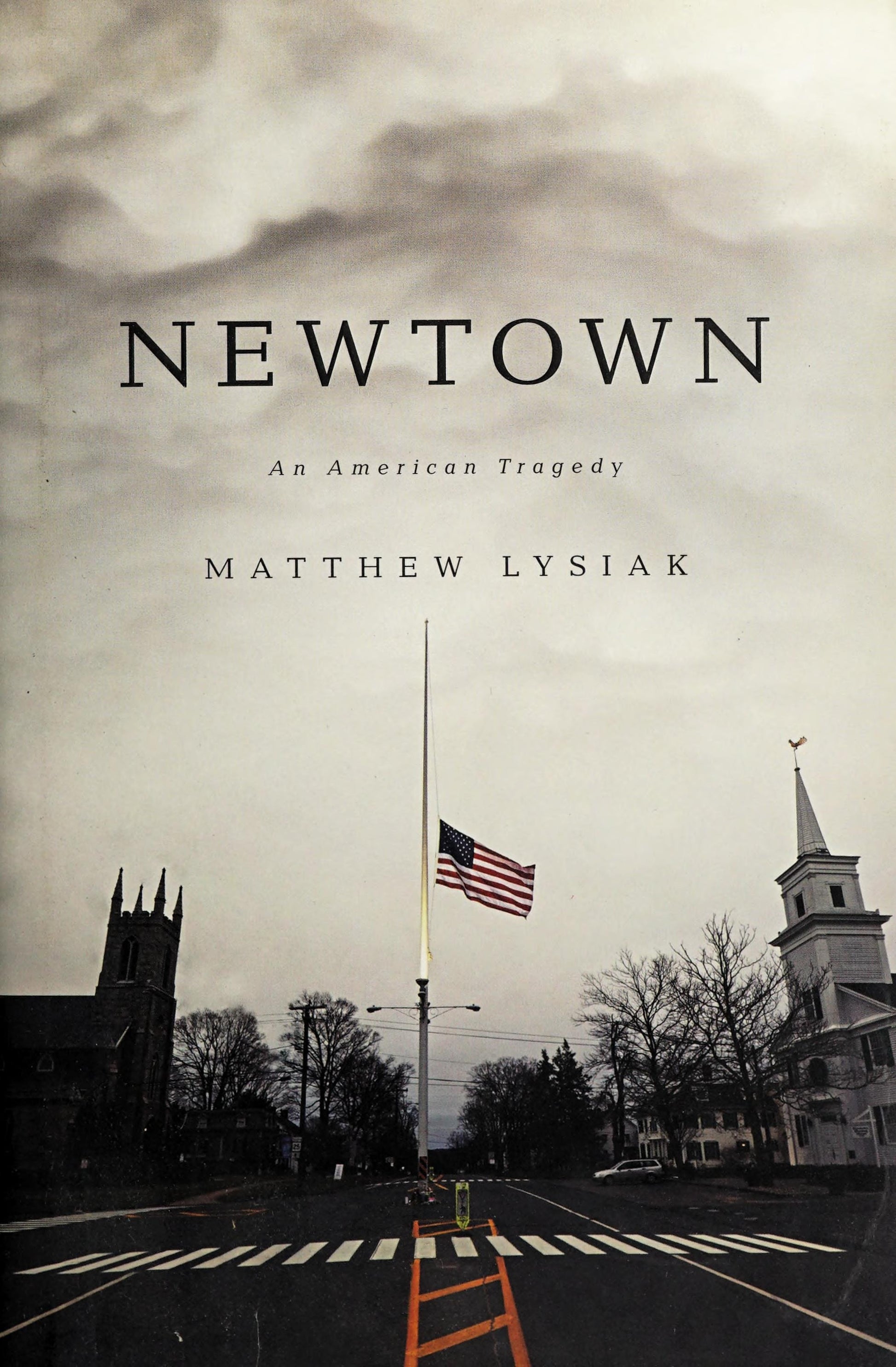 Book cover of 'Newtown: An American Tragedy' by Matthew Lysiak with a somber scene of a half-mast American flag and a church.