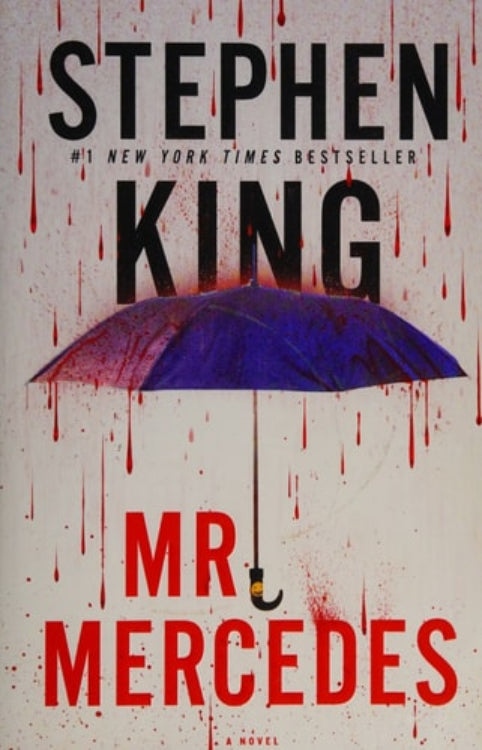 The cover of the book 'Mr. Mercedes: A Novel' by Stephen King, featuring a purple umbrella and blood splatters on a white background.