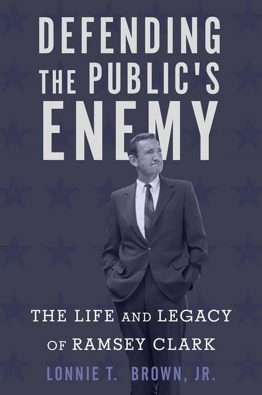 Book front cover of "Defending the Public's Enemy: The Life and Legacy of Ramsey Clark (ISBN: 9781503601390)" by Lonnie T. Brown, Jr., featuring the author posing in a suit and tie, looking off into the distance. 