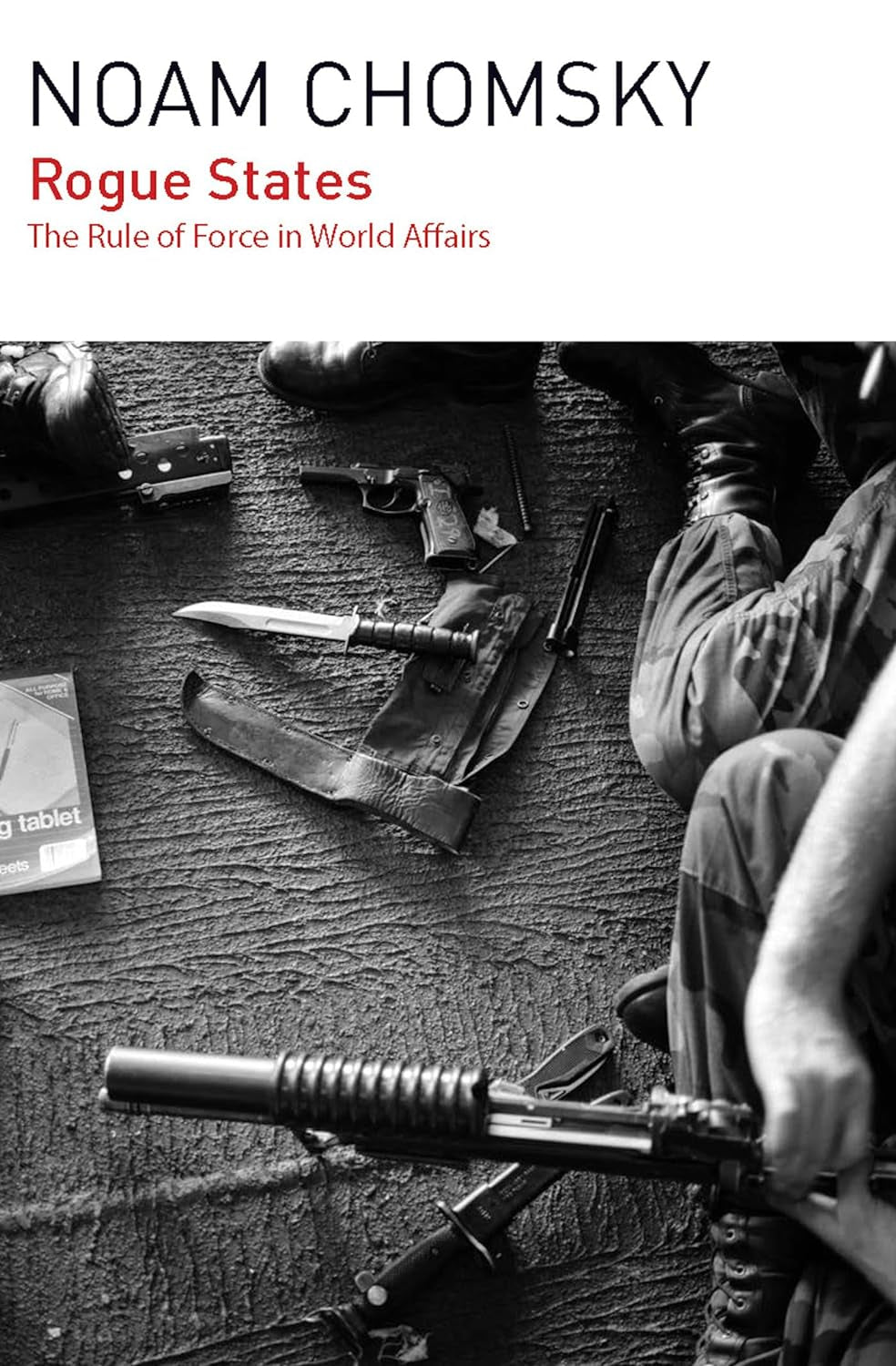 Book cover of 'Rogue States: The Rule of Force in World Affairs' by Noam Chomsky, featuring a silhouette of a person with a rifle and various military artifacts in the background.