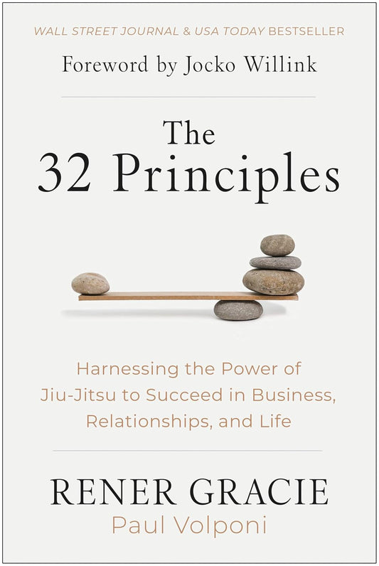 The cover of the book 'The 32 Principles' by Rener Gracie and Paul Volponi, featuring a title text and a visual of a stack of pebbles on a scale, symbolizing balance.