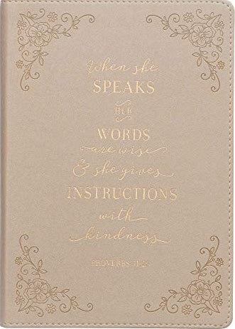 Beige notebook with gold text and floral designs on a white background