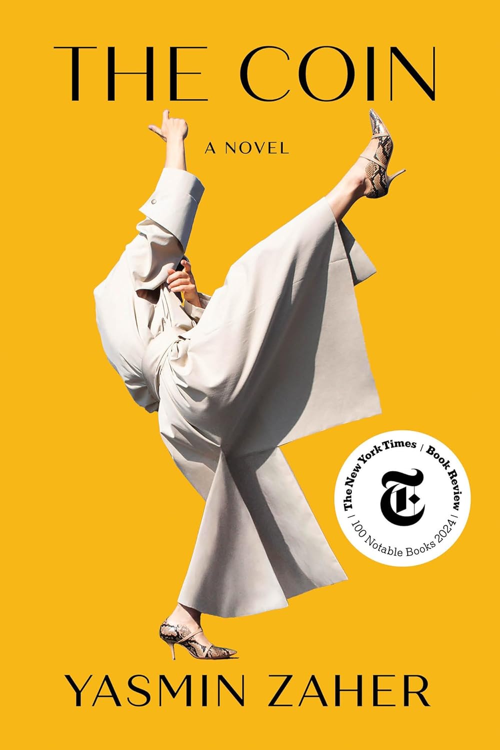 Book cover of 'The Coin' by Yasmin Zaher with a yellow background and a person in a white outfit.