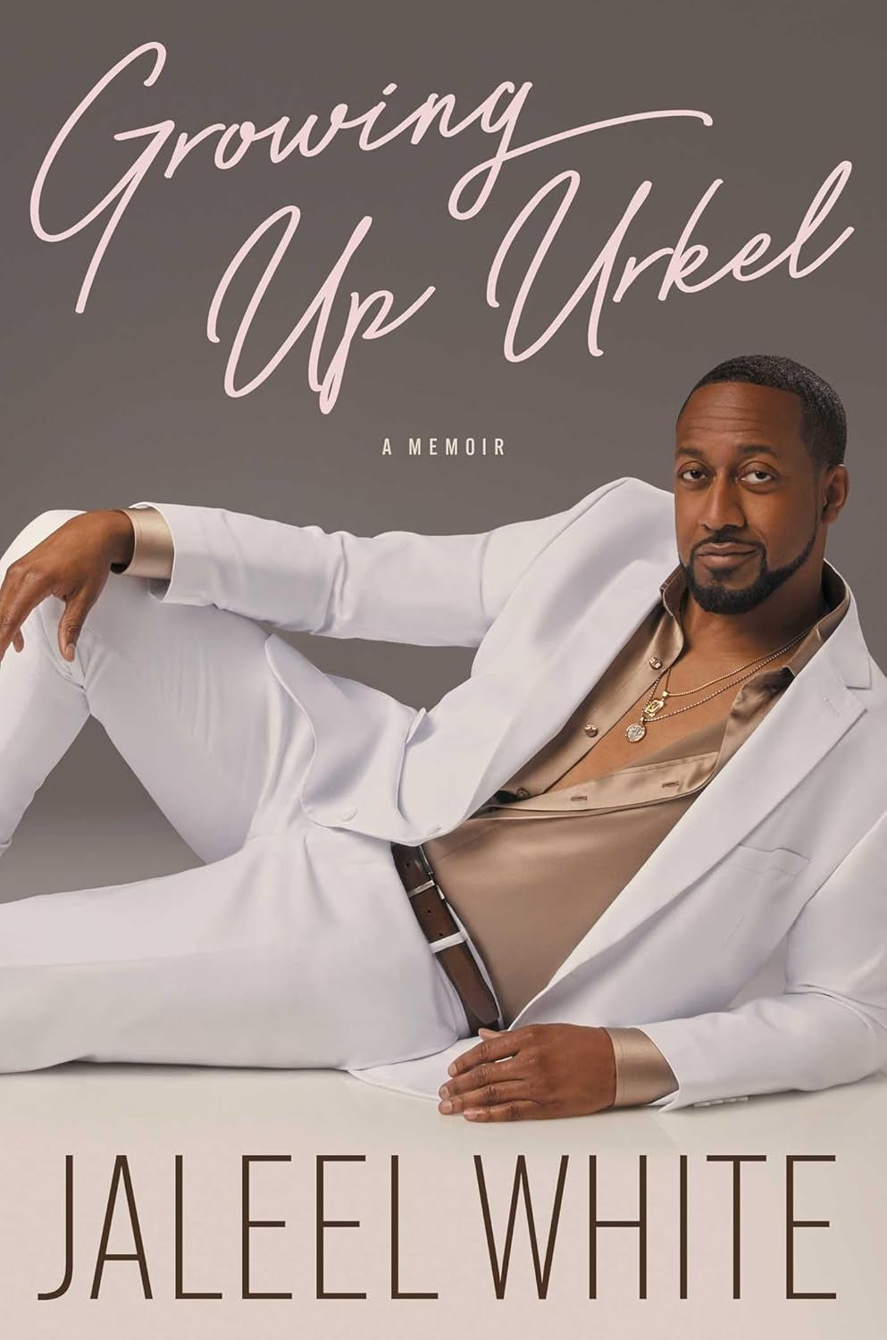 The cover of the book 'Growing Up Urkel' by Jaleel White features a man in a white suit with a casual pose, with the title and author's name at the top.