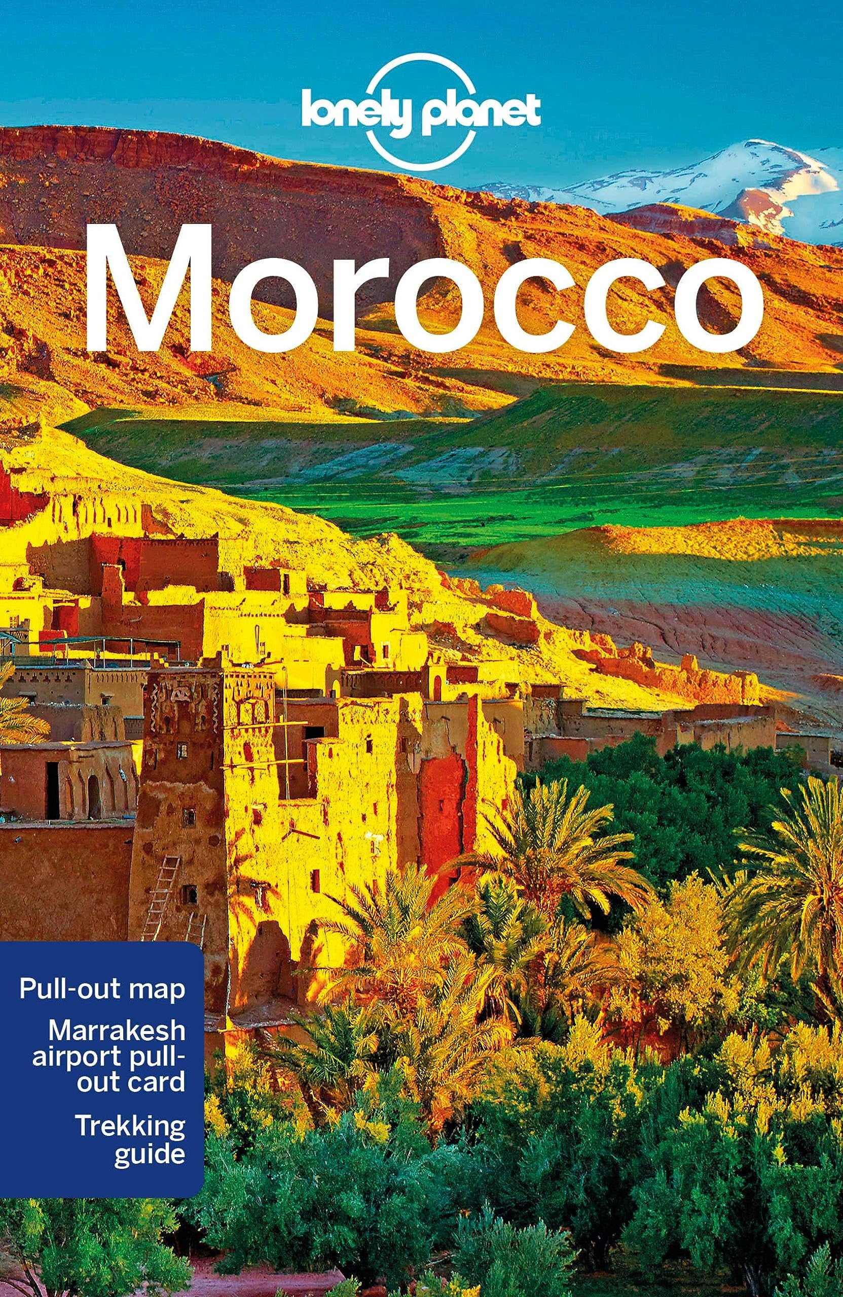 Lonely Planet Morocco travel guide cover featuring a warm-toned landscape of Marrakech with adobe buildings, palm trees, green hills, and blue mountains under a bright sky. Large white text reads 'Morocco' and the Lonely Planet logo appears at the top.