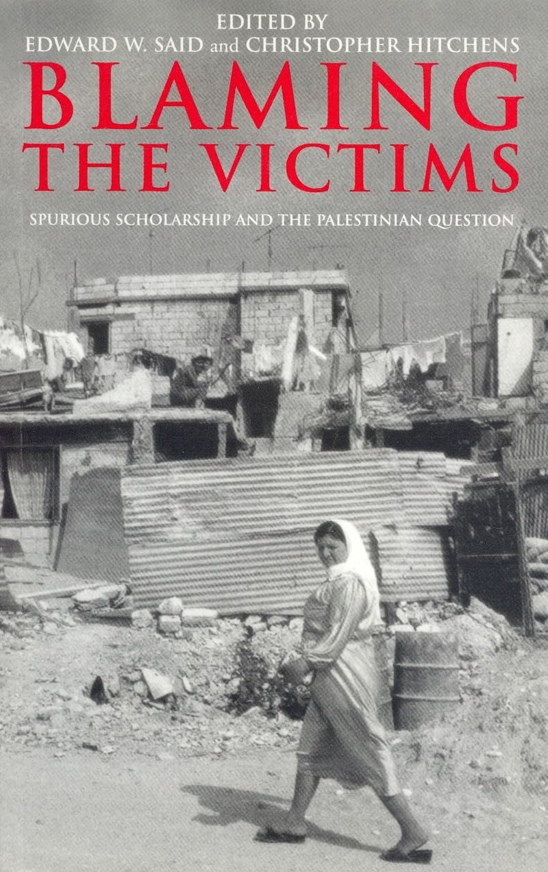 Book cover of 'Blaming the Victims: Spurious Scholarship and the Palestinian Question' by Edward W. Said and Christopher Hitchens, showing a black and white photo of a woman walking in a destroyed city, with the editors' names at the top.