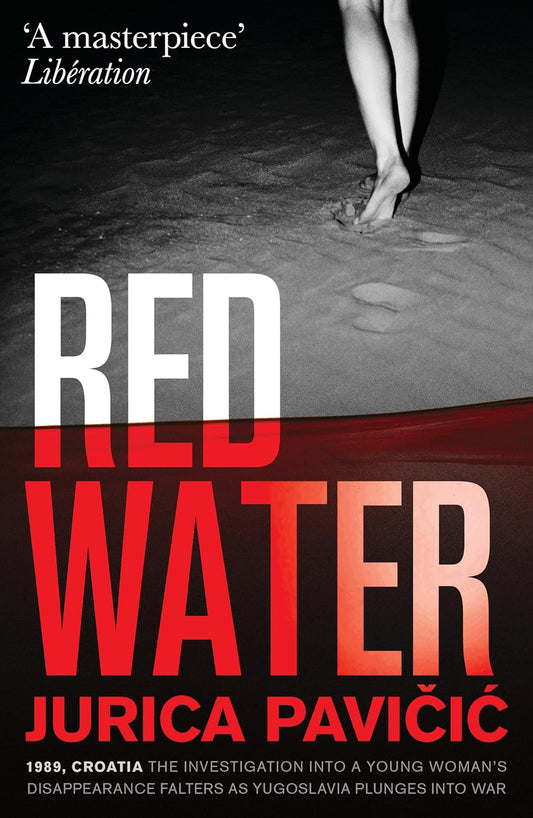 Book front cover of 'Red Water: A Masterpiece Novel' by Jurica Pavičić, featuring a pair of legs walking in sand or on a beach.