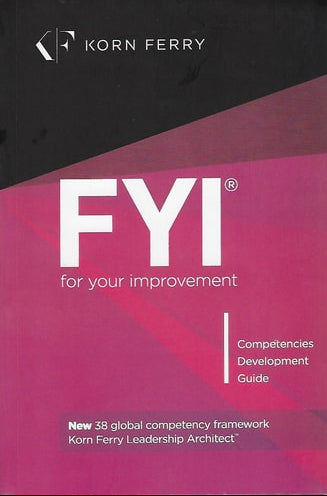 Cover of the book 'FYI: For Your Improvement - Competencies Development Guide' with pink and black color scheme and the Korn Ferry logo.
