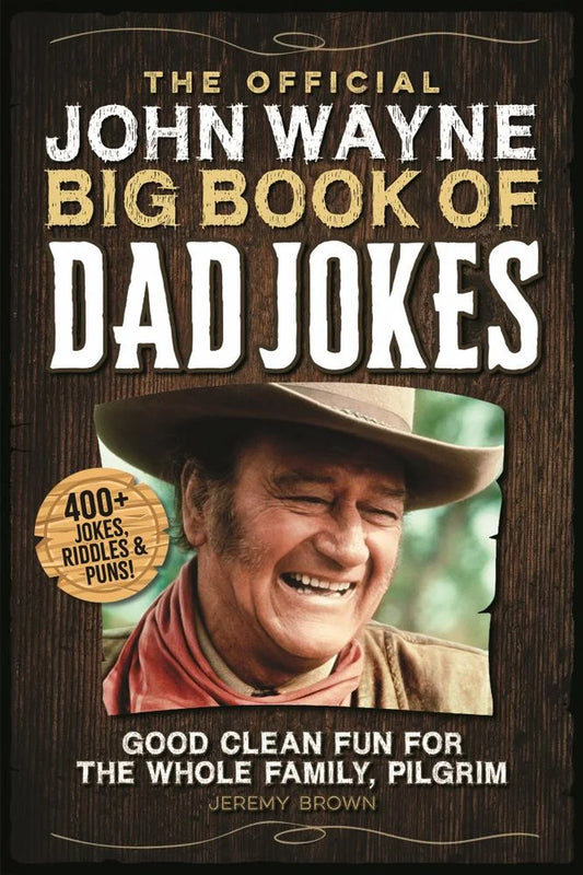 The cover of 'The Official John Wayne Big Book of Dad Jokes' featuring an image of John Wayne with a hat and sunglasses, smiling.