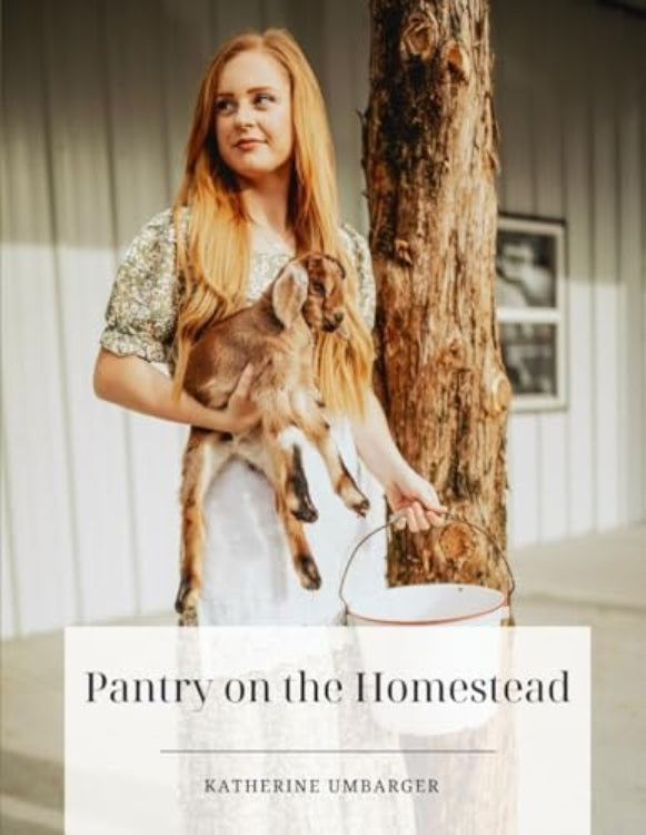 A person holding a small animal, possibly a goat, with a book titled 'Pantry on the Homestead' by Katherine Umbarger in the foreground.