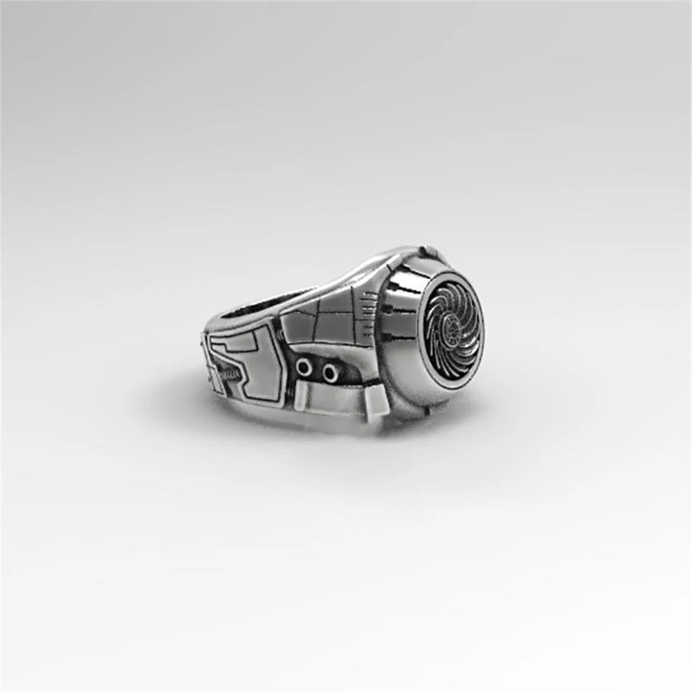 Silver ring with a detailed design on a light gray background
