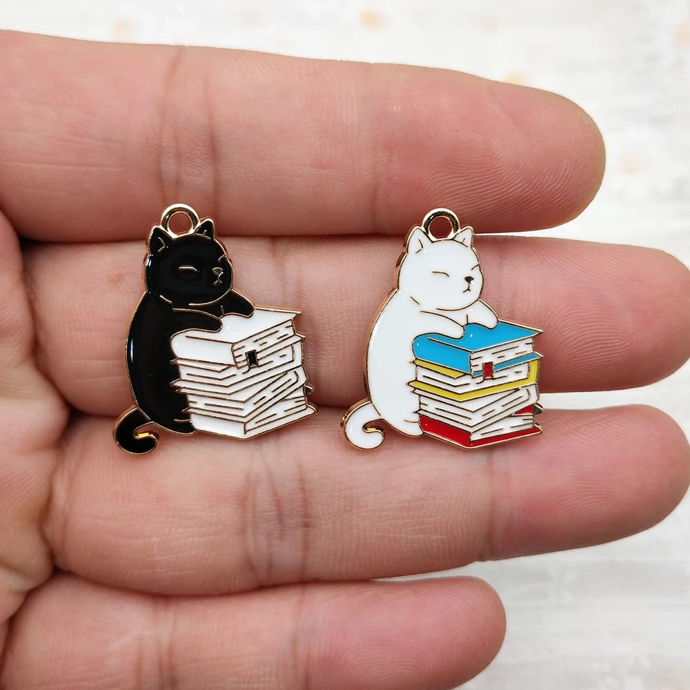 Pendant necklace showing a husky cat hugging a stack of books charm.