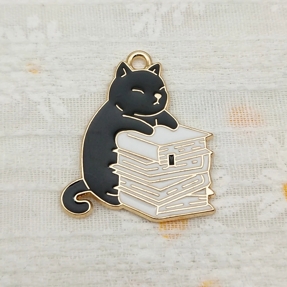 Pendant necklace showing a husky cat hugging a stack of books charm.