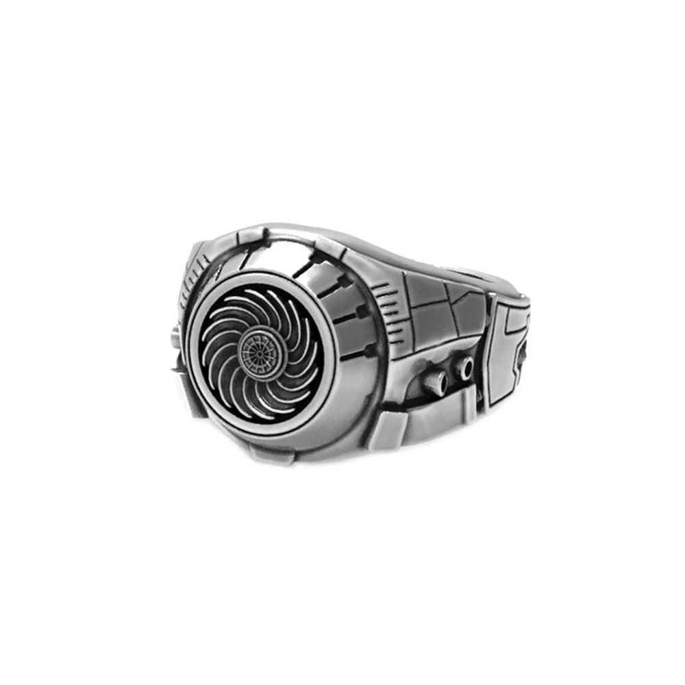 Silver ring with a detailed design on a white background