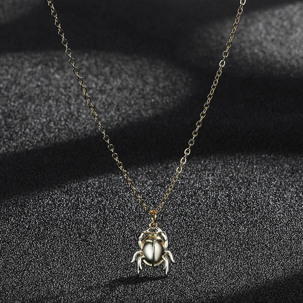 Necklace with a beetle pendant on a dark textured background