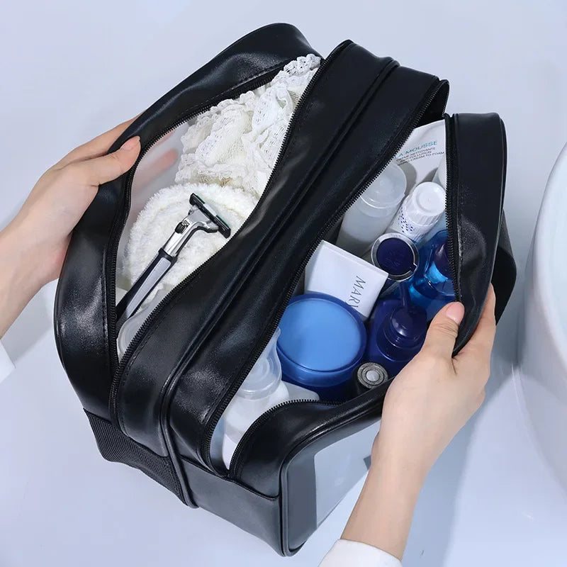 Black toiletry bag with personal care items on a light gray background