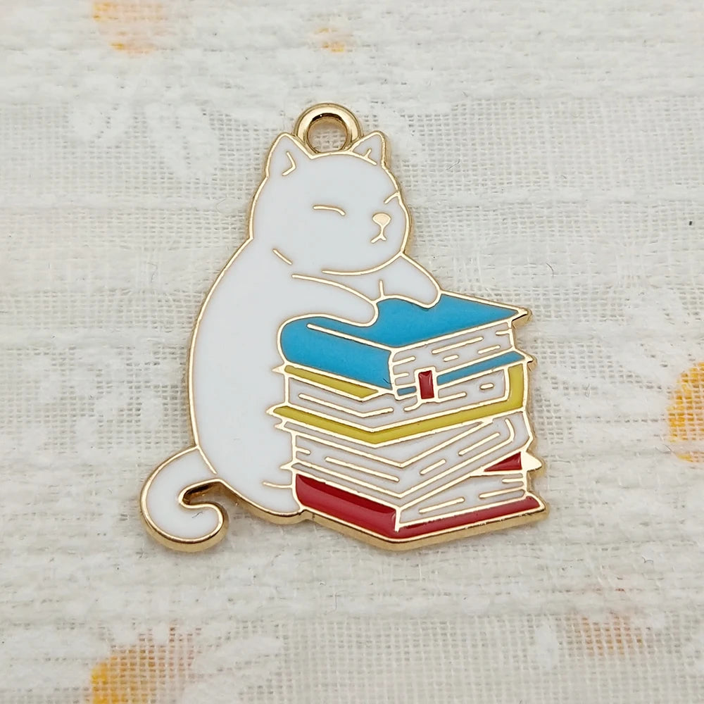 Pendant necklace showing a husky cat hugging a stack of books charm.