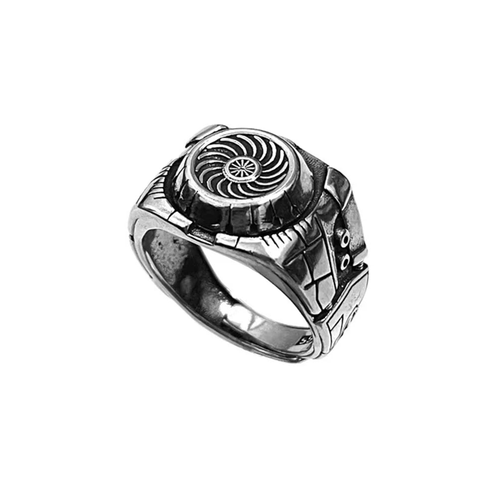 Silver ring with intricate design on a white background