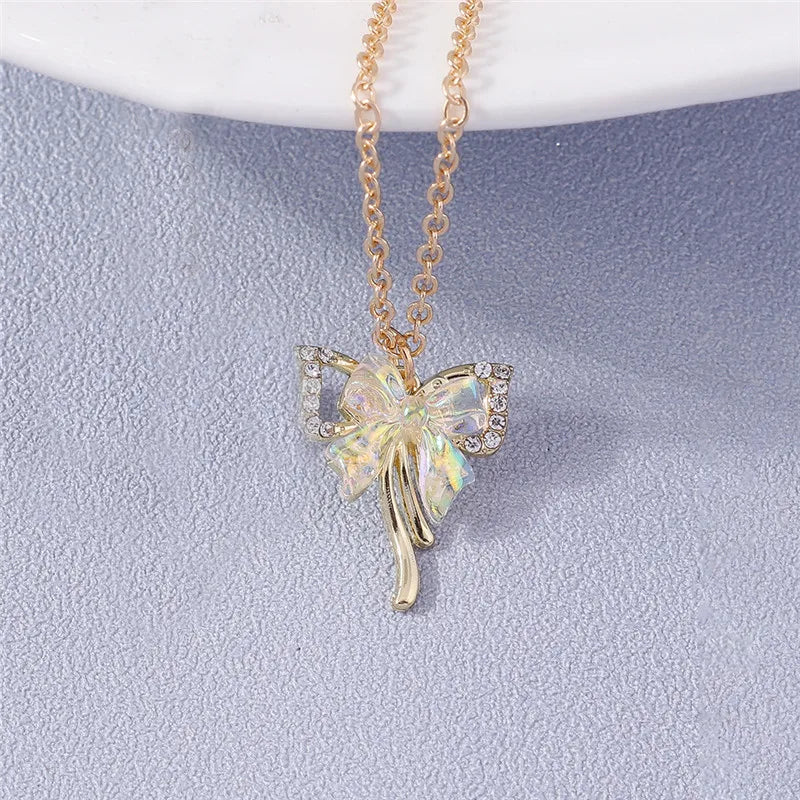 Butterfly-shaped pendant necklace on a light blue background