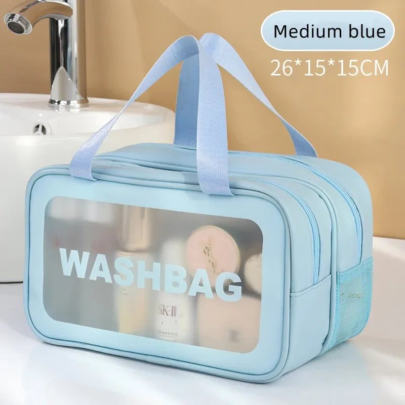 Light blue washbag with transparent side panels on a bathroom counter