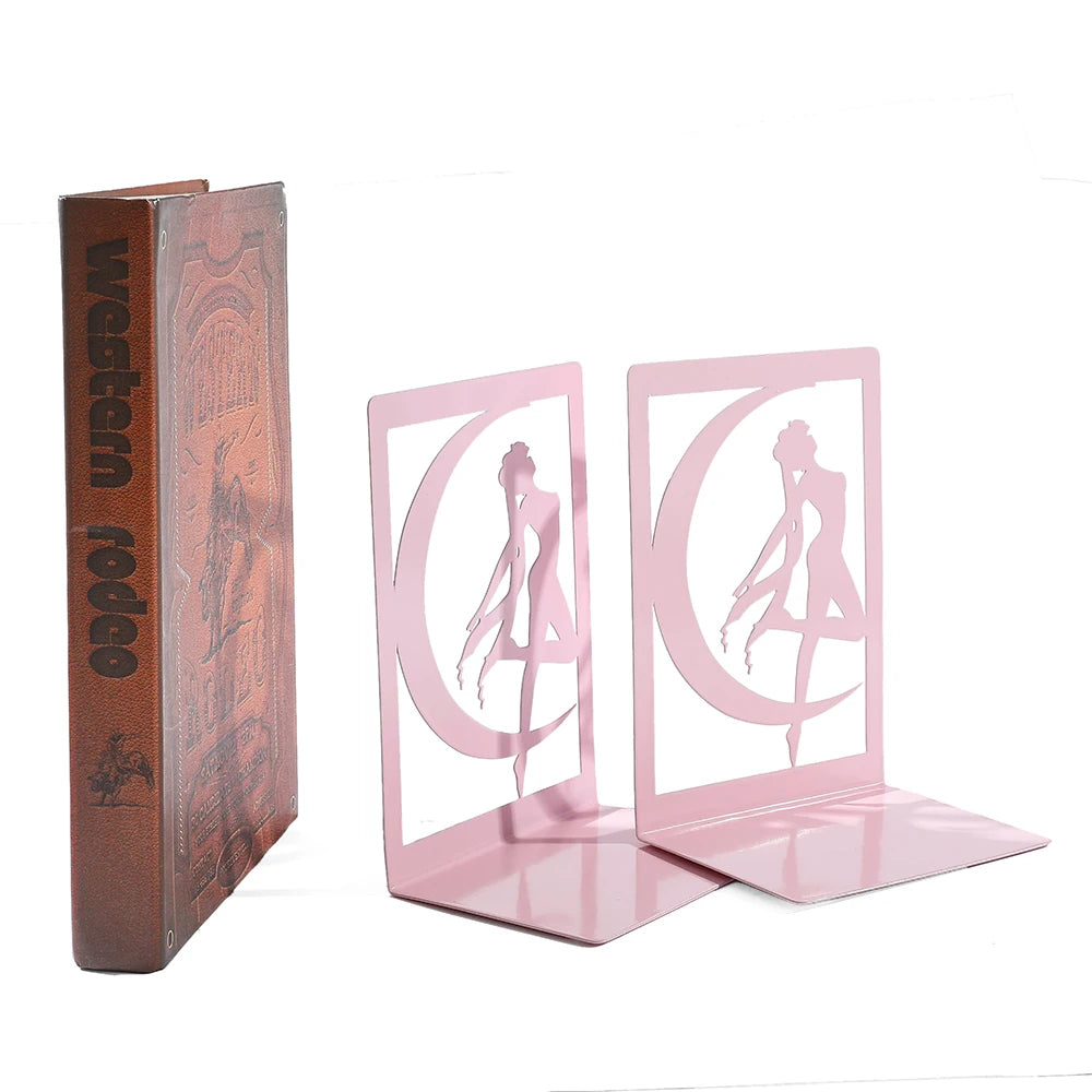 Pink metal bookends with a 'Ballerina Fairy' design next to a book titled 'Western Rodeo'.