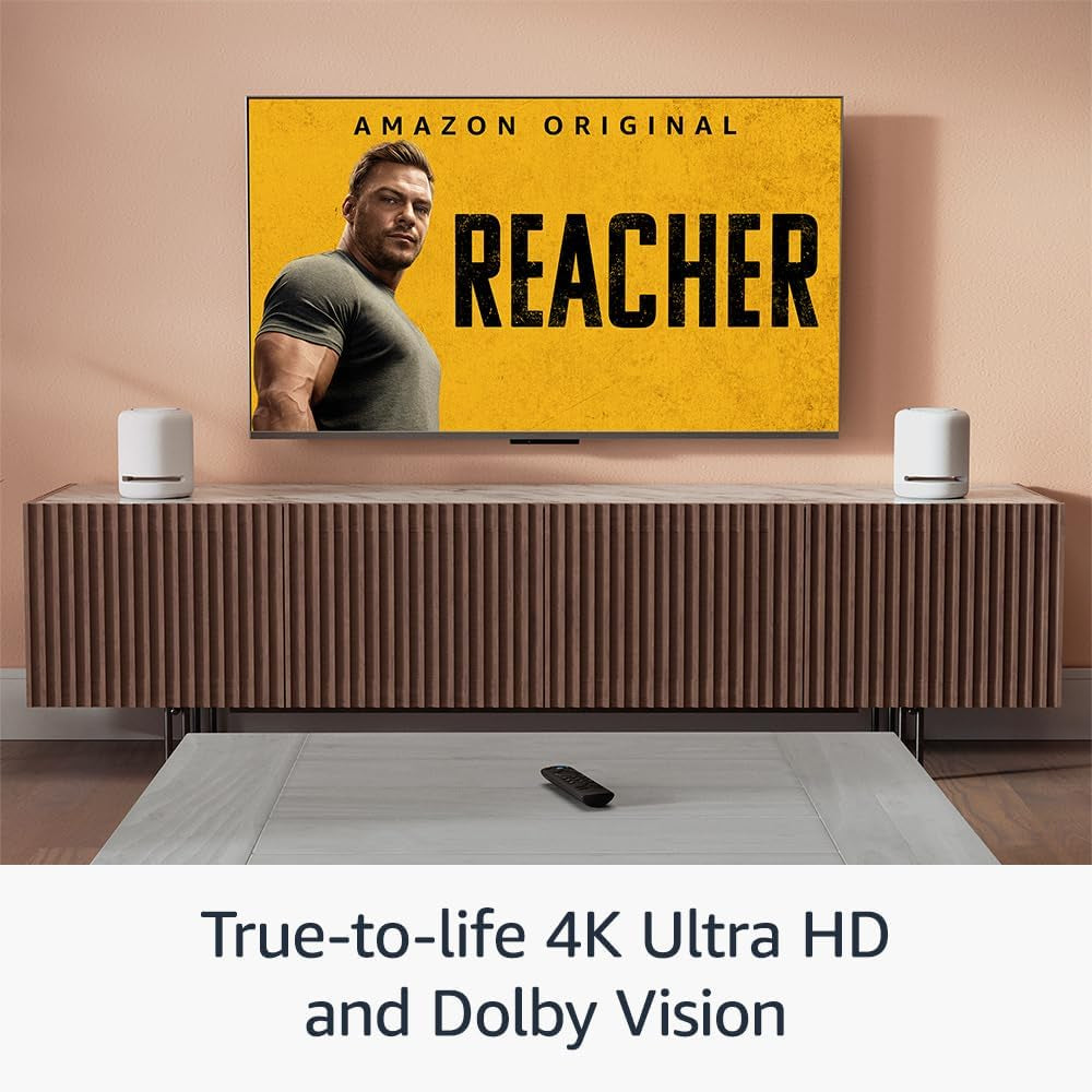 AI Powered Fire TV Stick displayed streaming on a mega screen tv in living room area with remote on table.