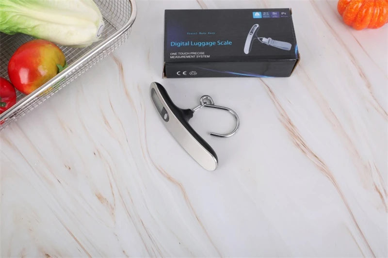 The AirportPRO digital hanging luggage scale with LCD screen being used in kitchen for food measurement and portion weight.